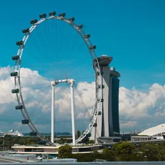 Ferris Wheel beside high-rise building during daytime