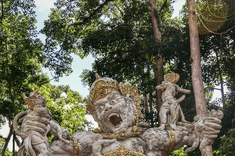 A statue of a god in a forest