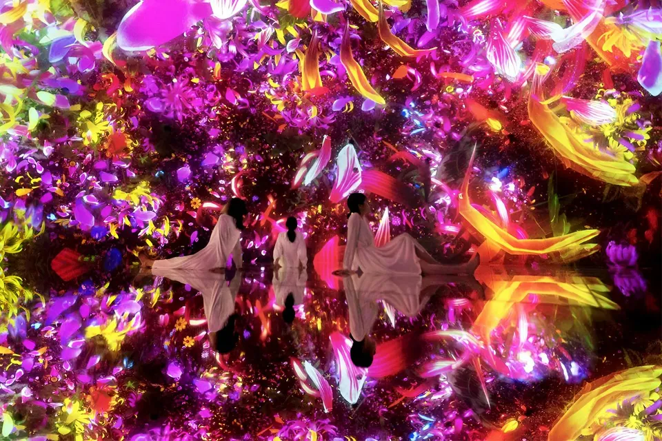 Visitors in immersive digital art installation at TeamLab Planets Tokyo.