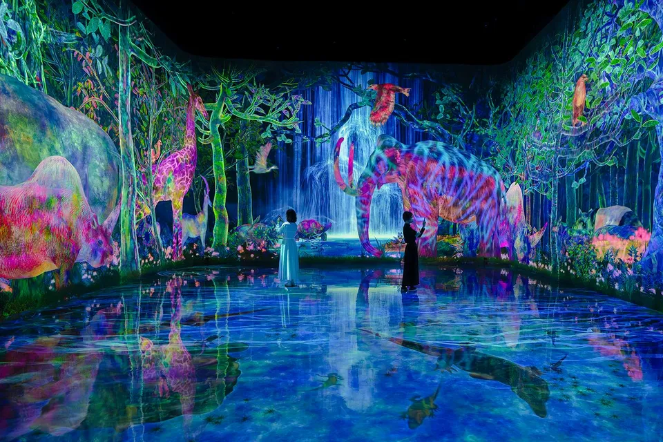 Interactive digital forest with colorful animals at teamLab Planets, Tokyo.