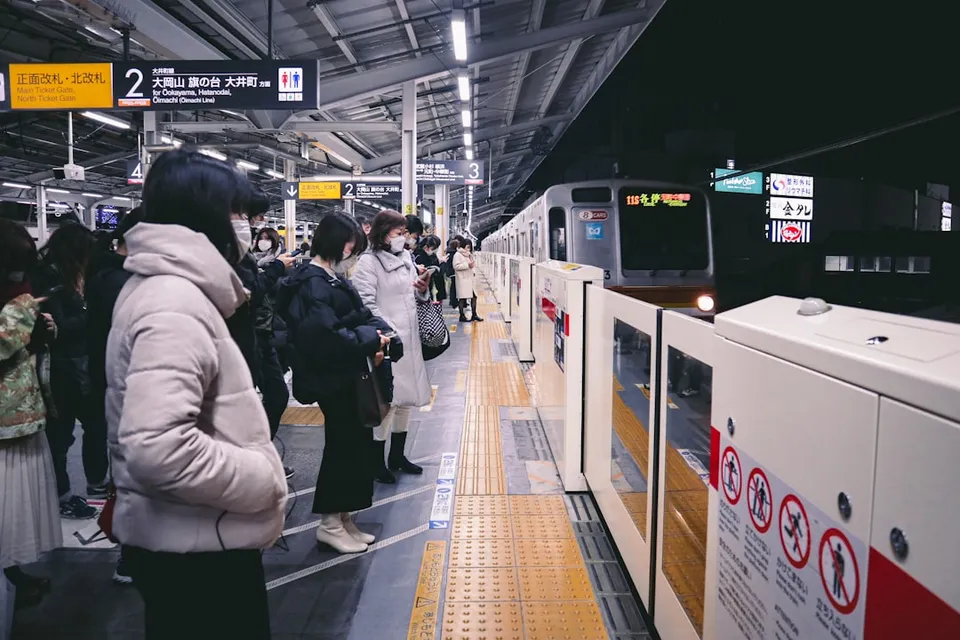 a group of people waiting at a train station