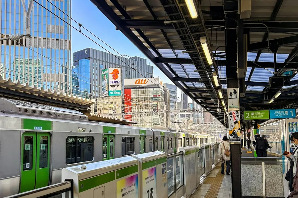 a subway station with people waiting for the train
