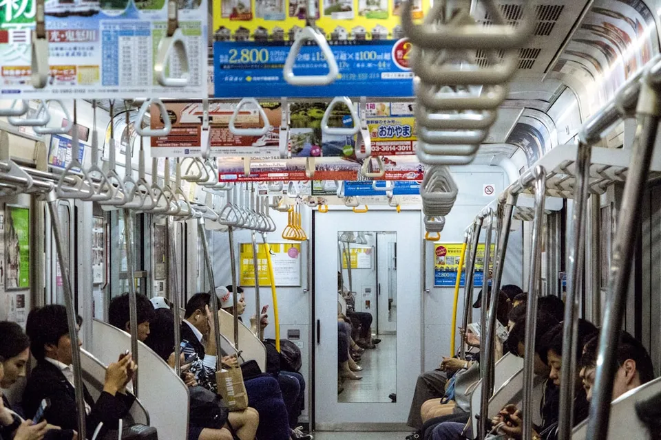 a group of people sitting on a subway train