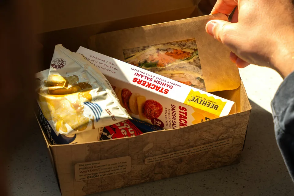 Lunch box with sandwich and snacks on Milford Sound Extended Cruise.