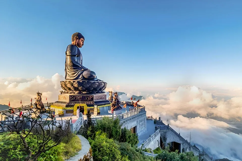 Buddha statue at Sun World Fansipan Legend, Vietnam, surrounded by clouds and mountain views.