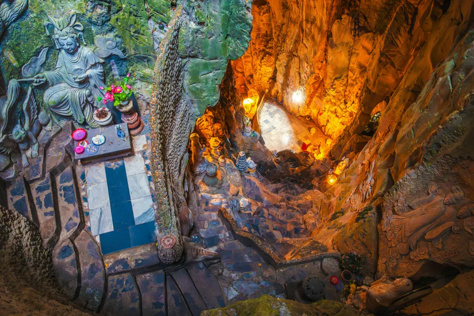 Interior view of Am Phu Cave with stone carvings and altar, Marble Mountains, Đà Nẵng, Vietnam.