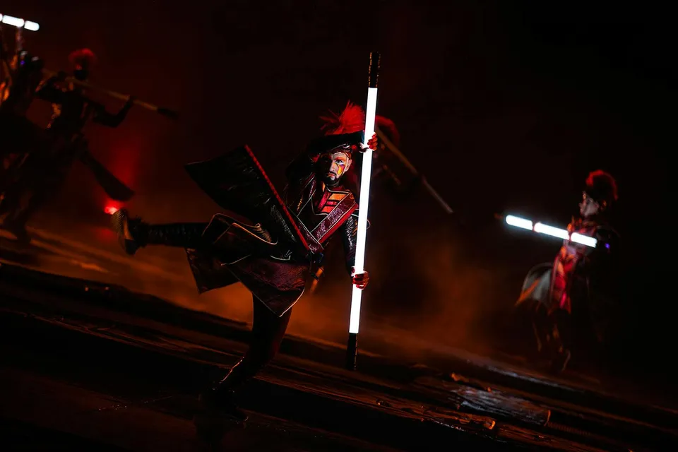 Performers with illuminated staffs in the Kiss of the Sea Show.