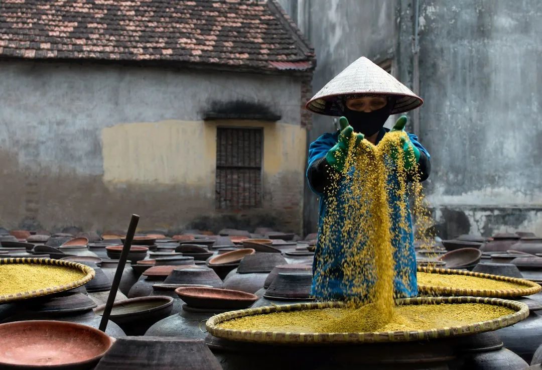 A woman standing in front of a bunch of pots