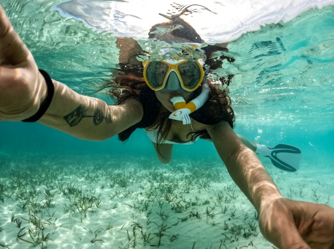 Woman snorkeling in the clear, blue ocean