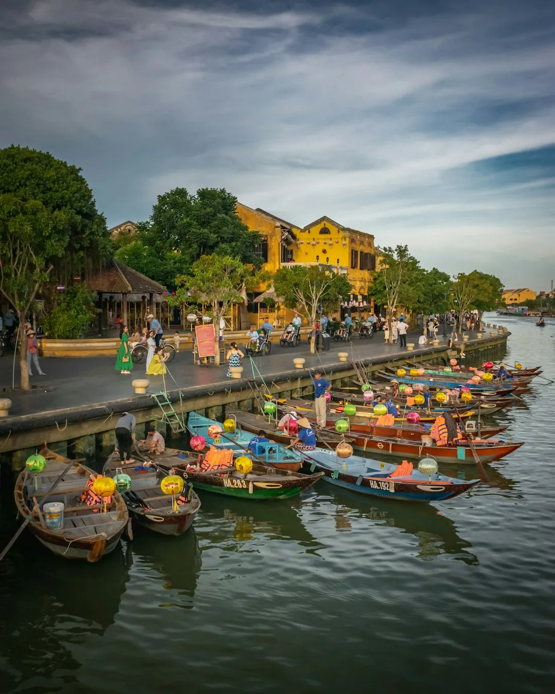 a group of boats are parked on the side of a river