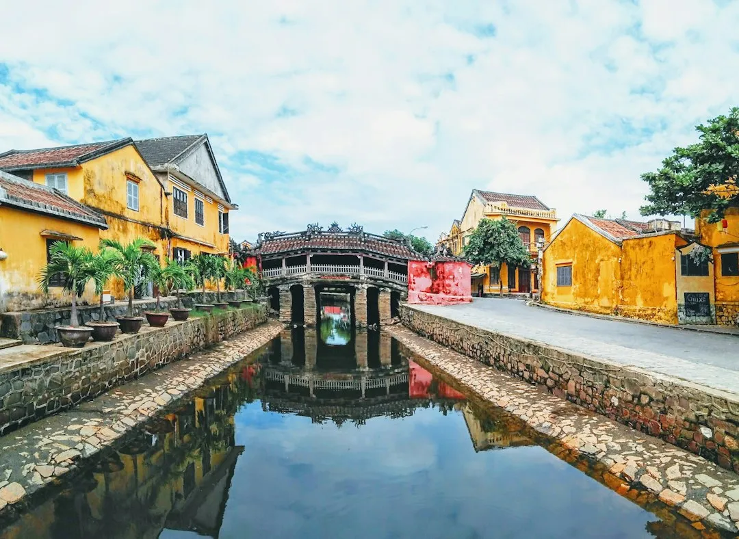 a river running through a city next to a yellow building
