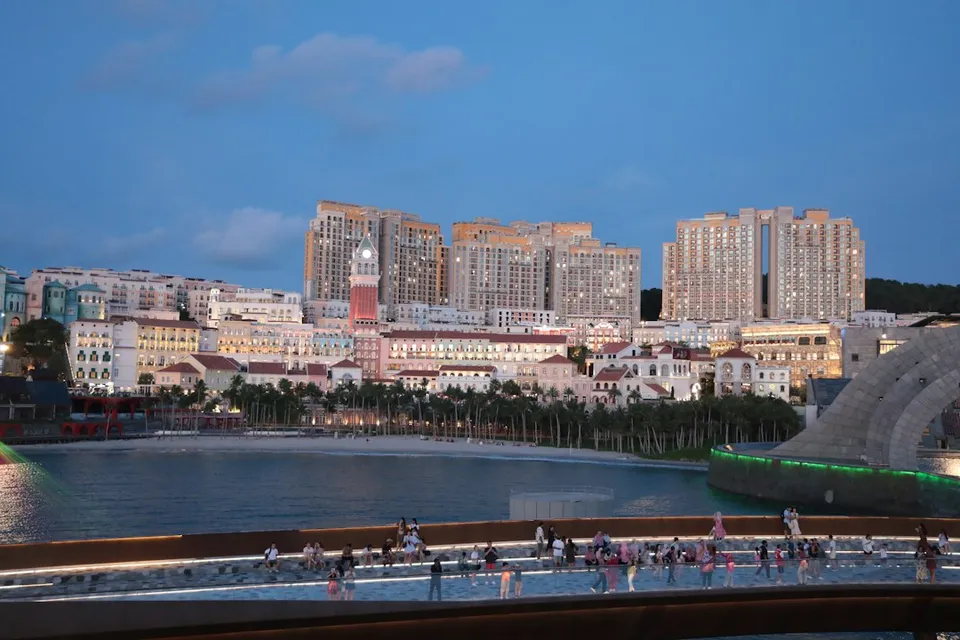 Cityscape with buildings and water at dusk