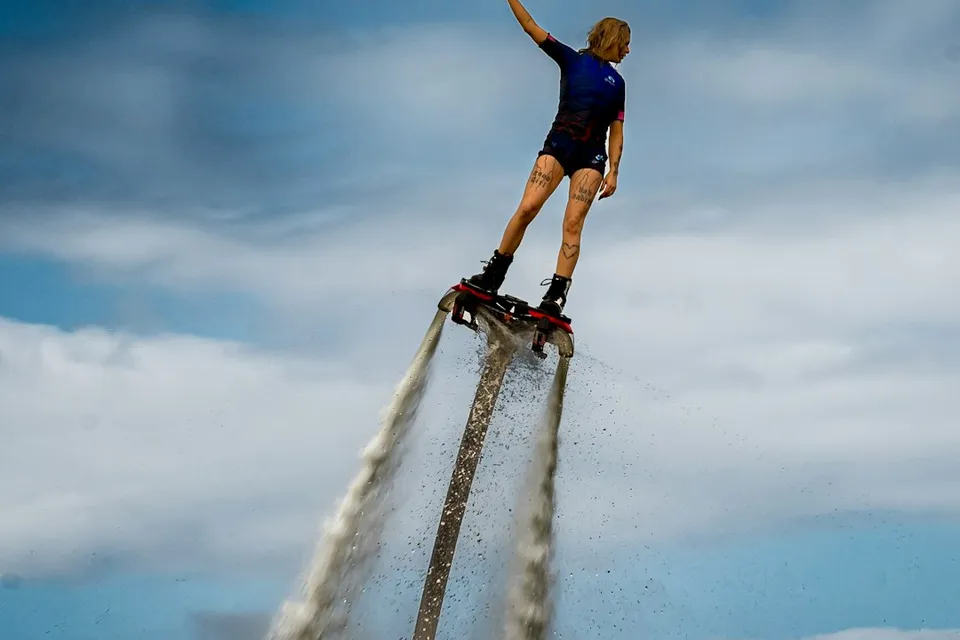 Woman on a flyboard spraying water into the sky