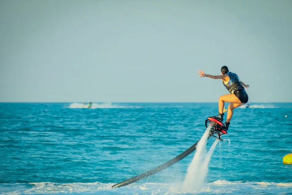 A person riding a hydroflight device on the ocean