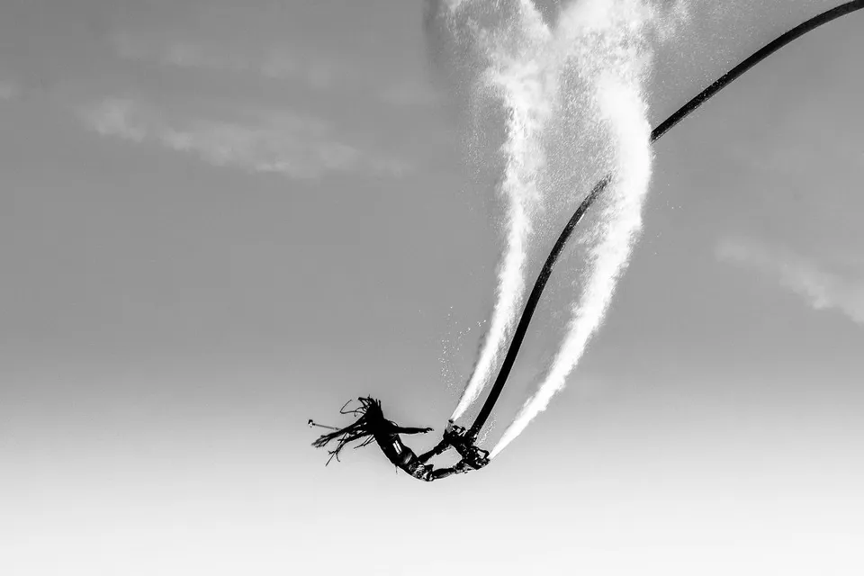 grayscale photography of person doing stunt on air