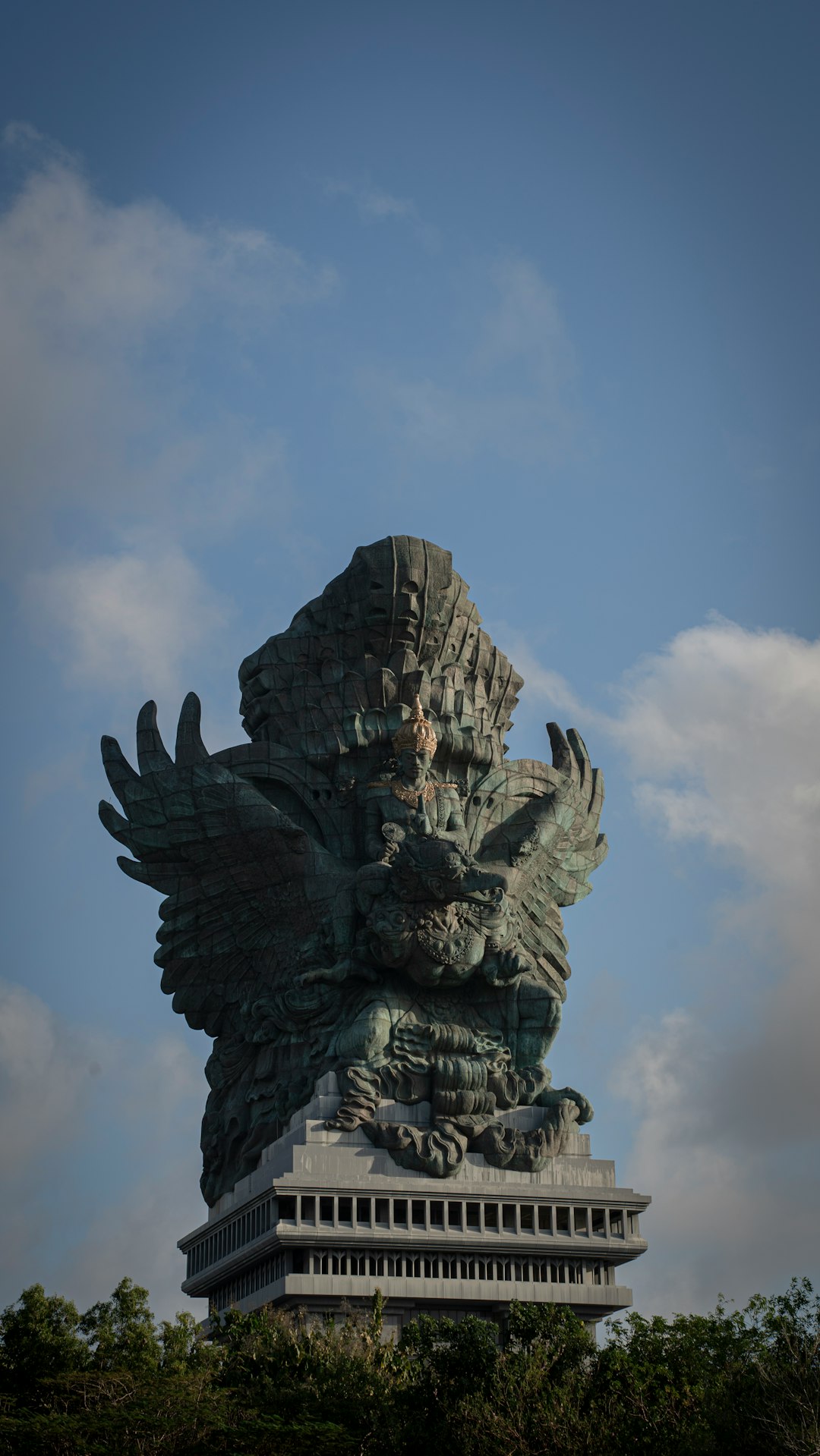 A statue of a winged creature on top of a building