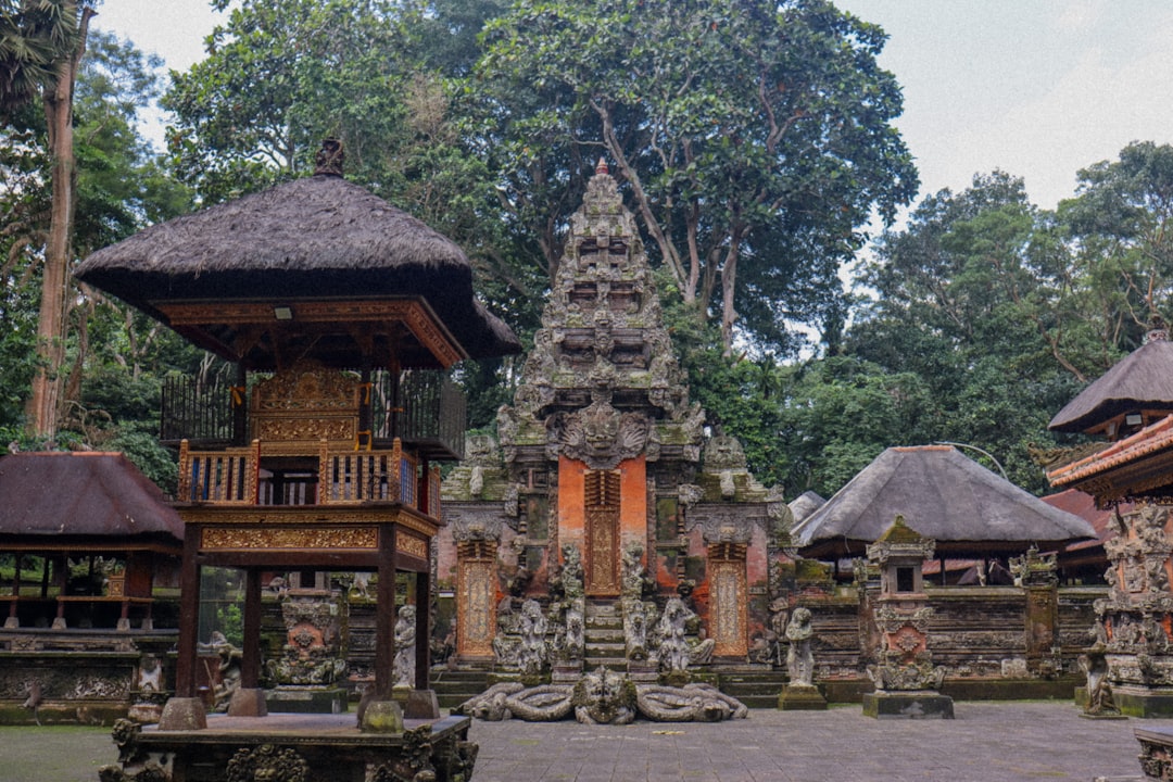 Ornate balinese temple complex surrounded by lush green trees