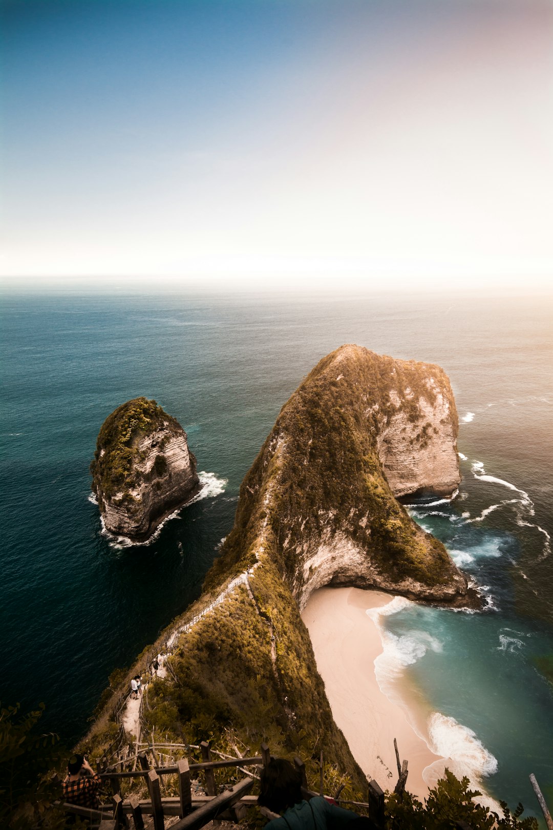 brown rock formation on body of water during daytime