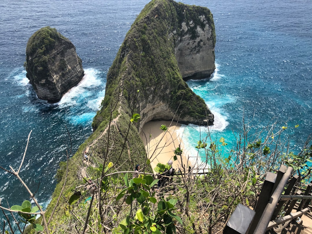 a couple of large rocks sitting on top of a lush green hillside