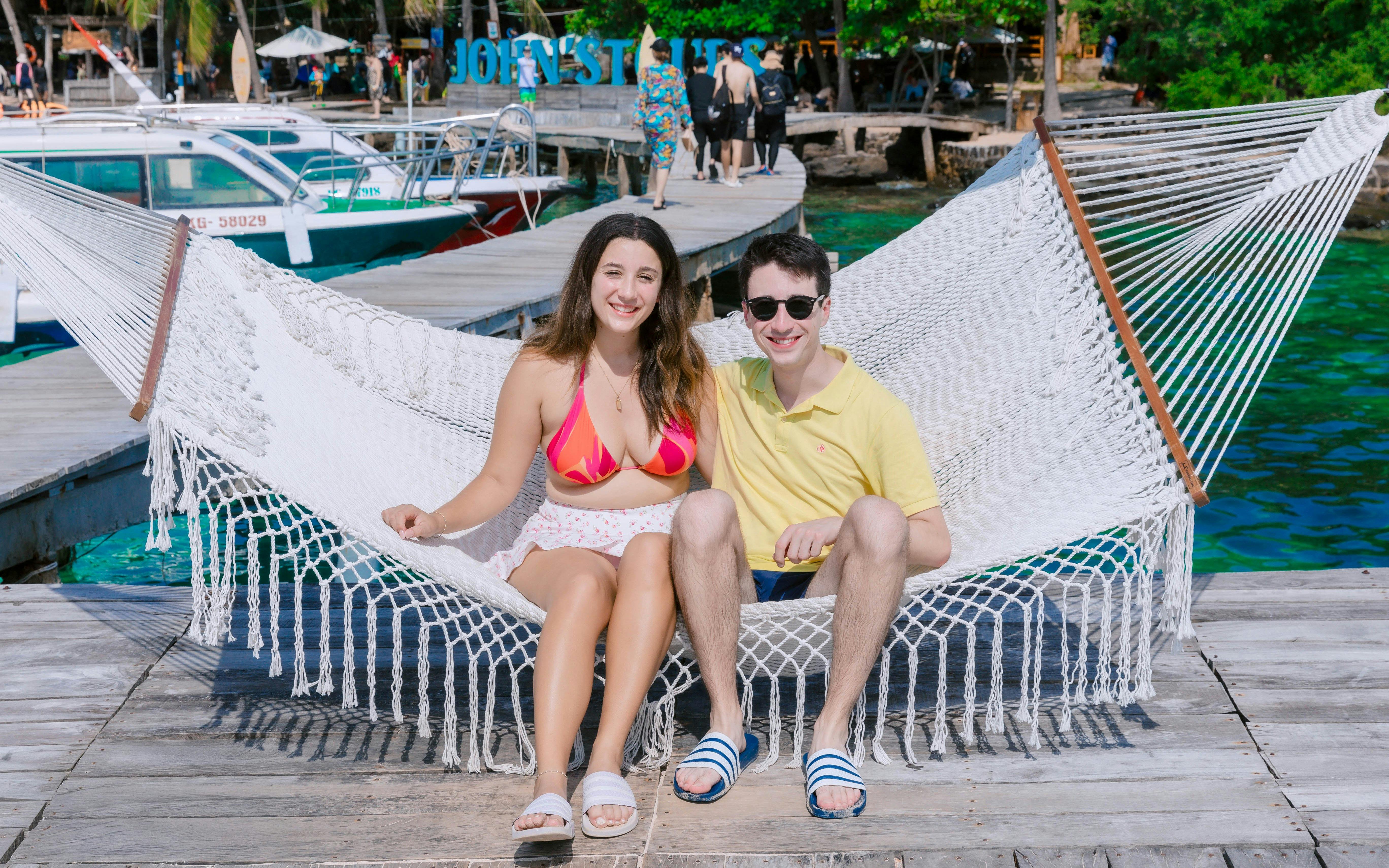 Tourists relaxing on a hammock at May Rut Trong Island pier.
