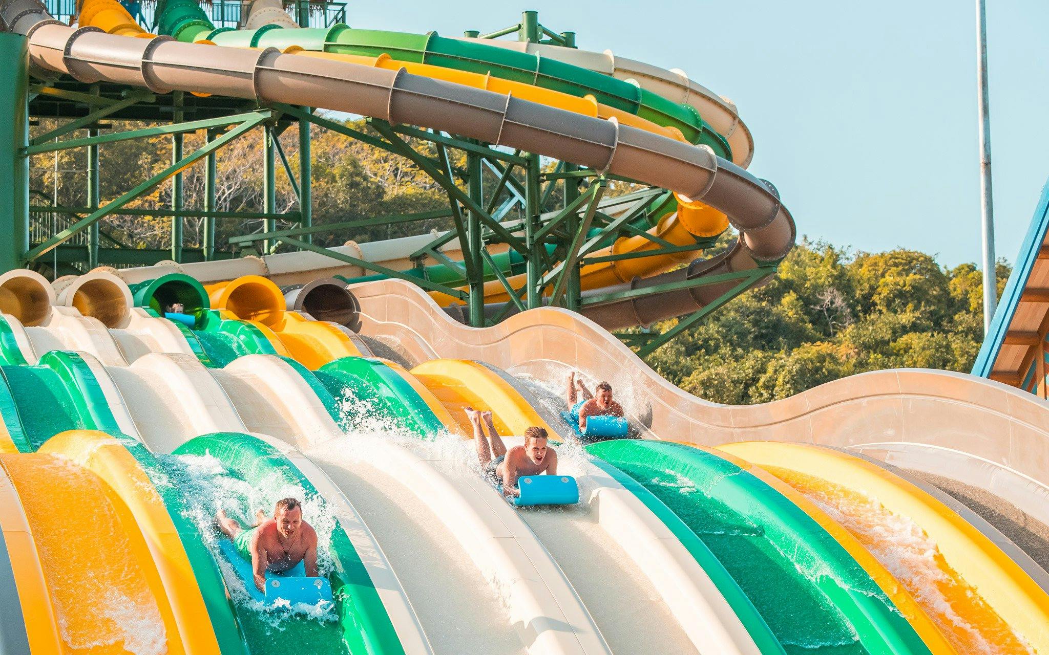 Water slides at Aquatopia Water Park, Hon Thom Island, with people enjoying the ride.