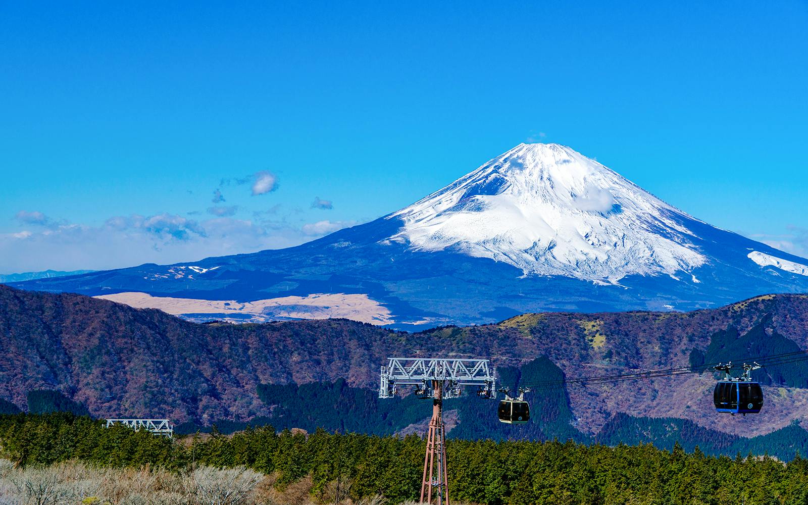 Ropeway gondolas with Mount Fuji in the background, Japan.