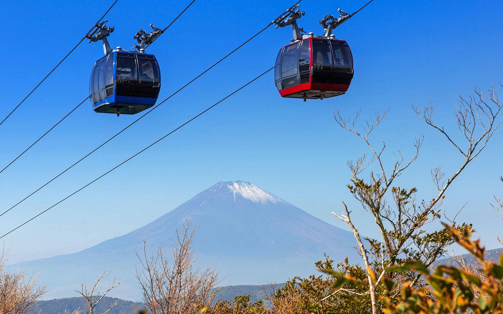 Ropeway gondolas with Mount Fuji in the background, Japan.