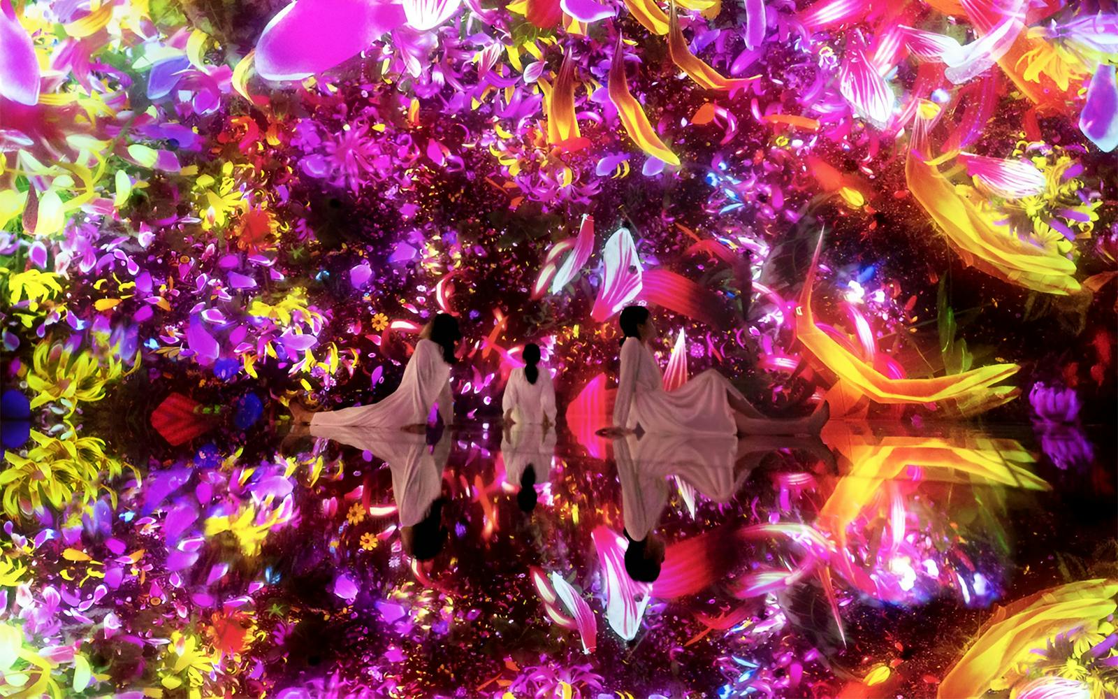 Visitors in immersive digital art installation at TeamLab Planets Tokyo.