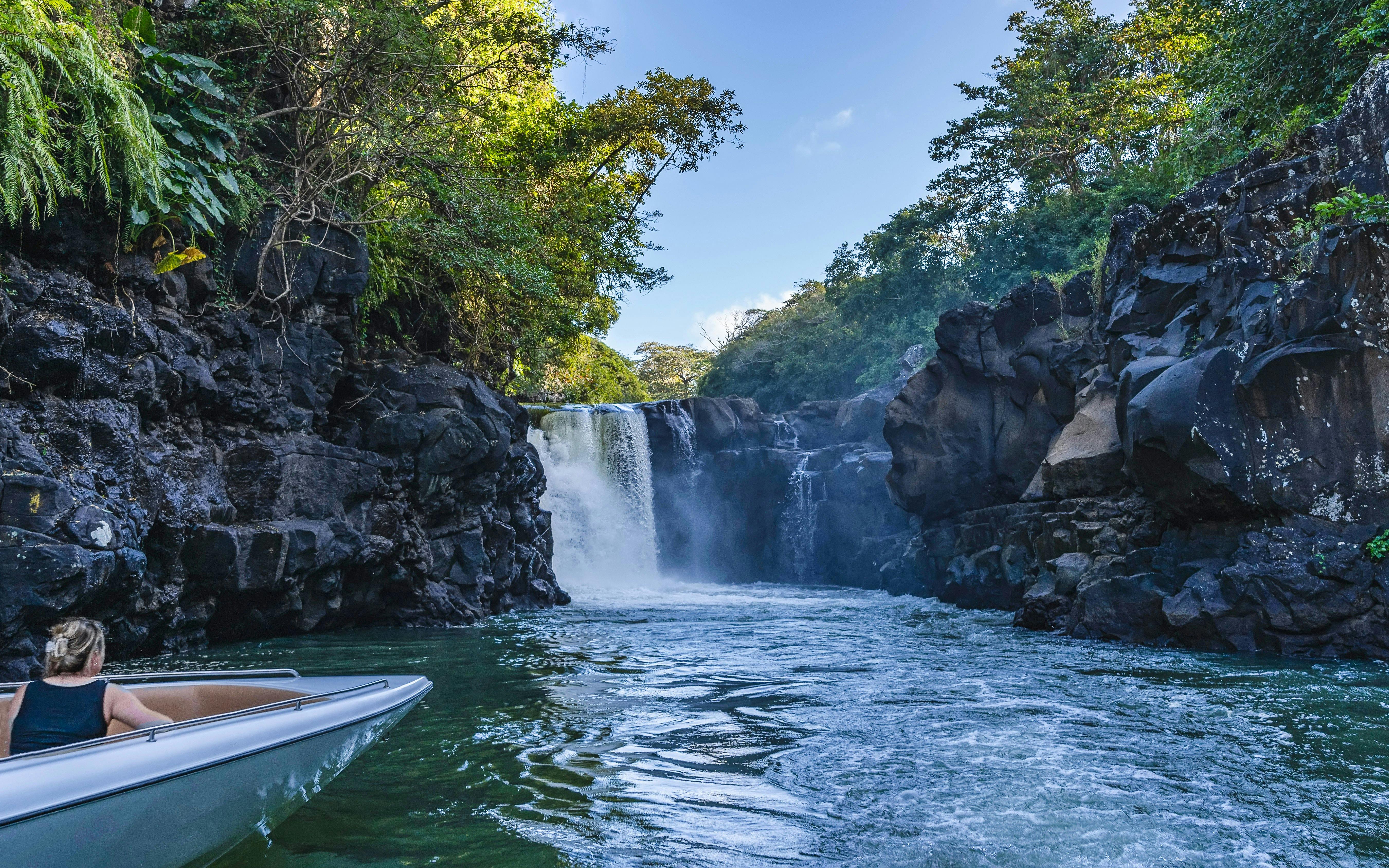 Boat approaching Grand River South East waterfall, Mauritius.
