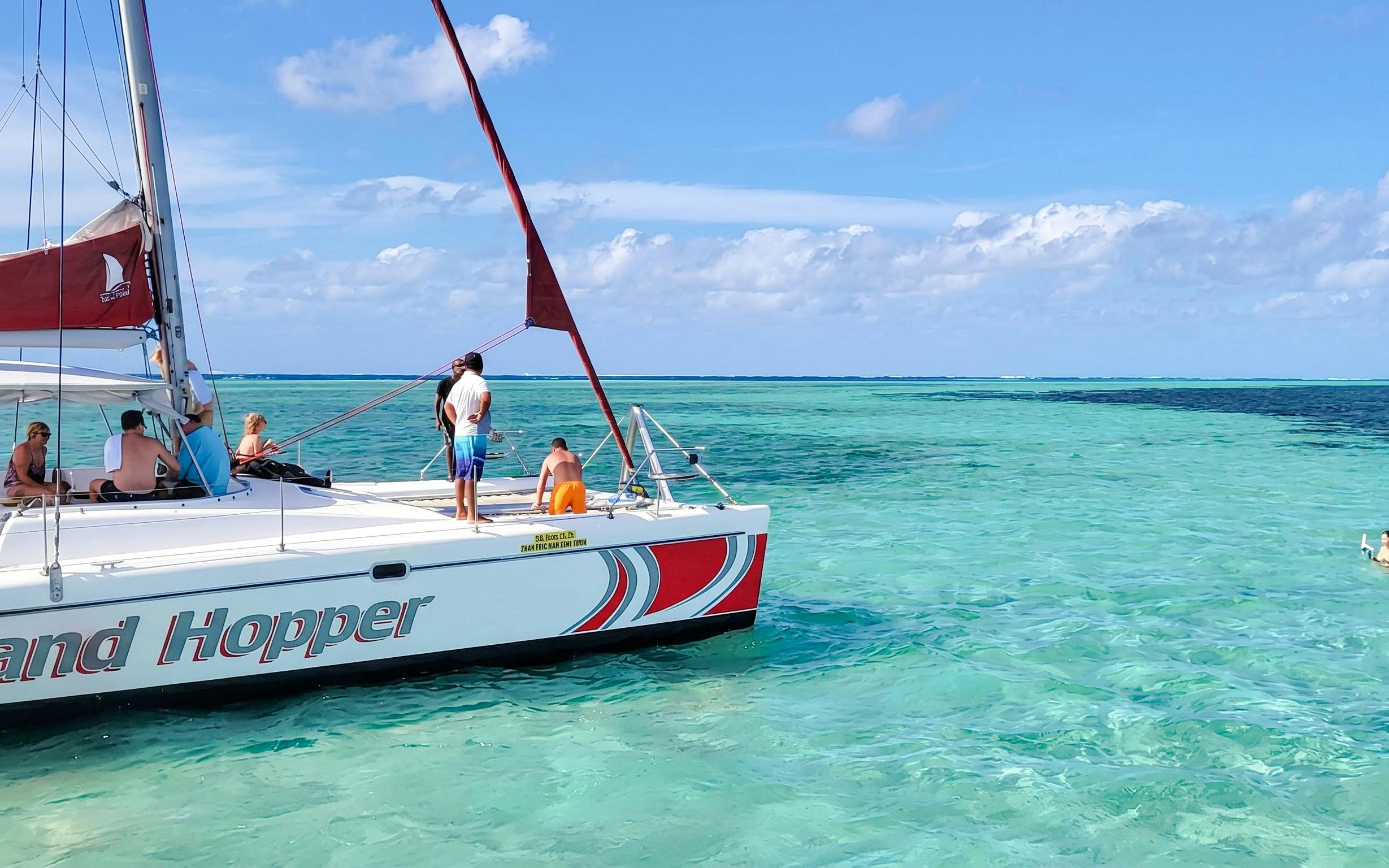 Catamaran sailing to Ile aux Cerfs from Pointe Jerome with passengers enjoying the ocean view.