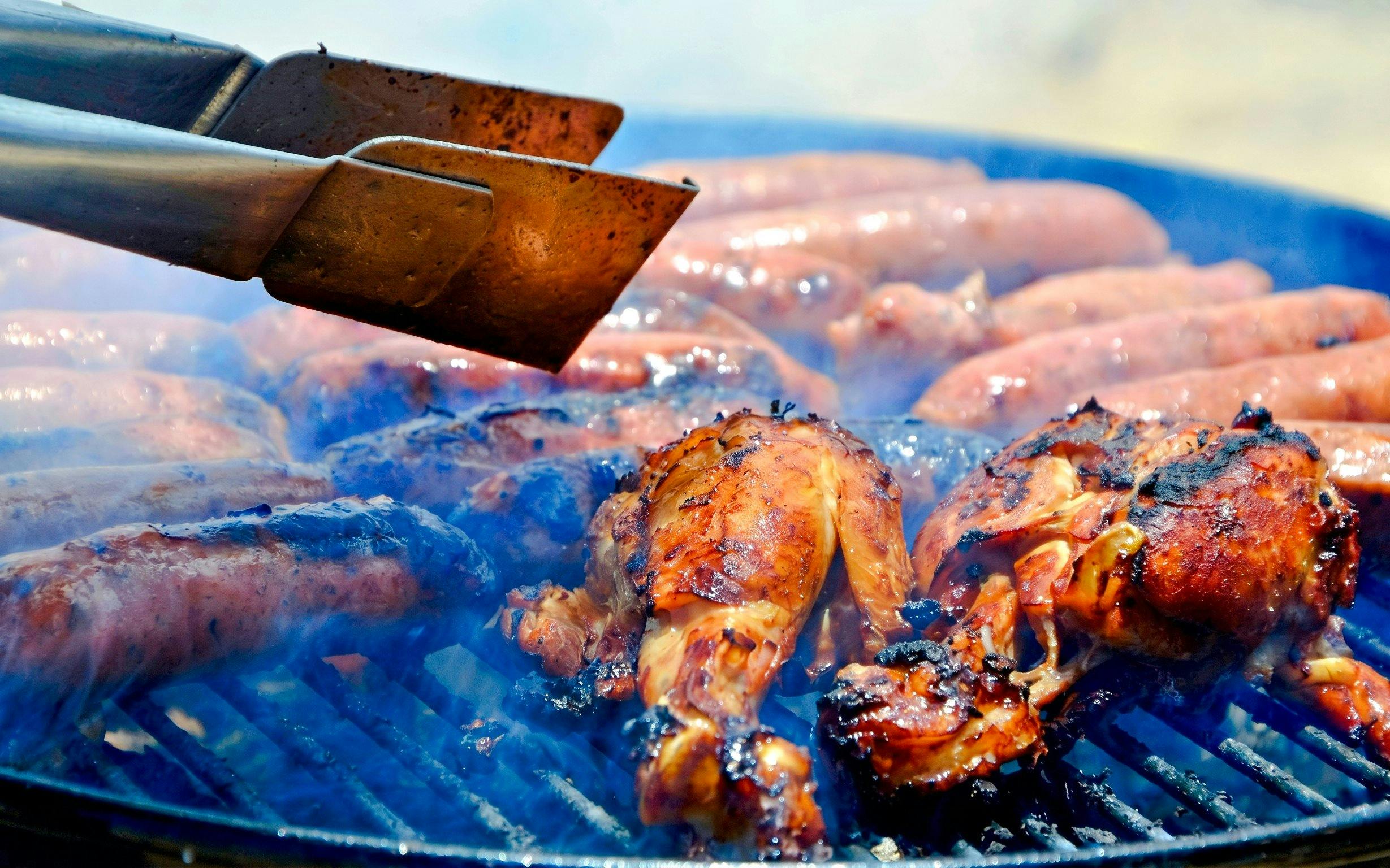 Grilled chicken and sausages on a barbecue, Mauritius local delicacies.