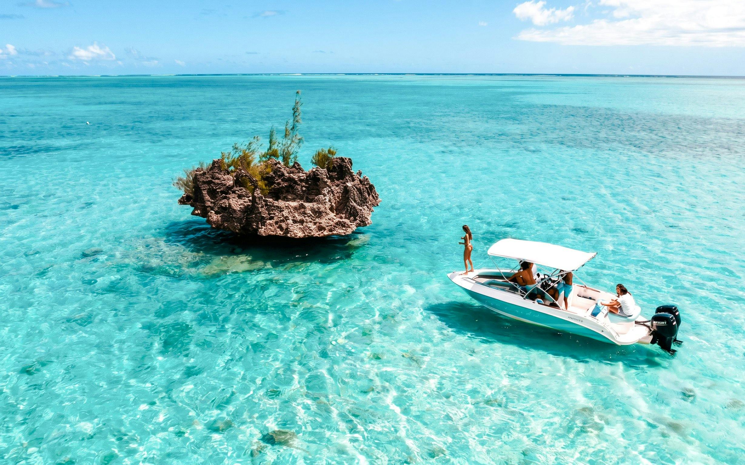 Speed boat near Crystal Rock in clear waters of Mauritius.
