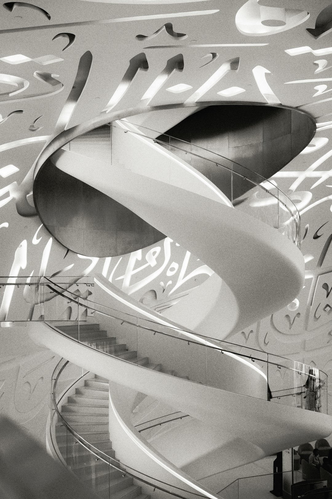A spiral staircase inside of a building with graffiti on the walls