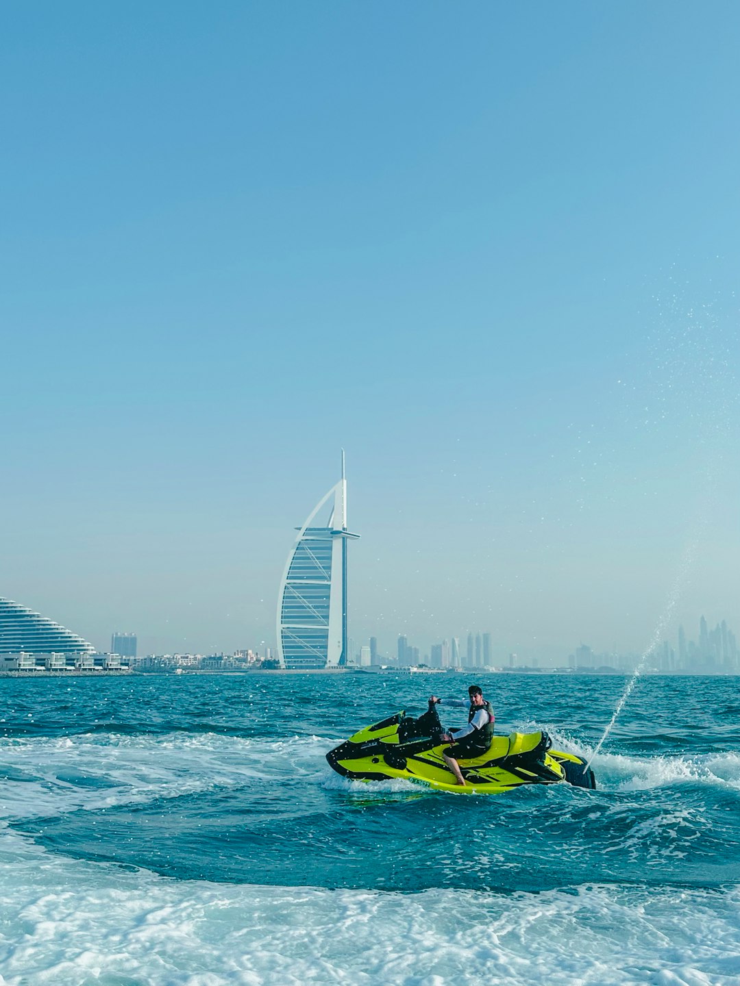 a man riding a jet ski on top of a body of water