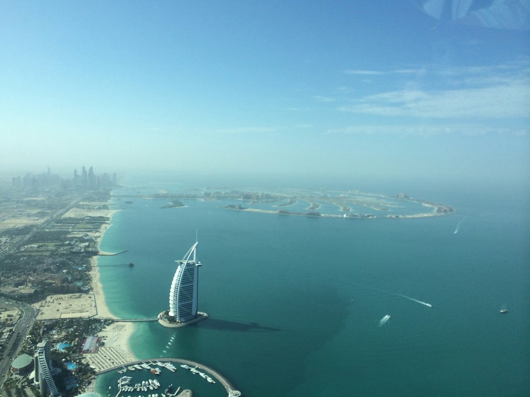 aerial view of white building near body of water during daytime