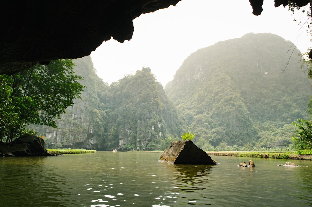 Limestone mountains rise above a tranquil river